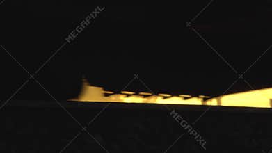 The train travels by rail against the backdrop of a beautiful sunny sunset, the wheels of the train close-up, background