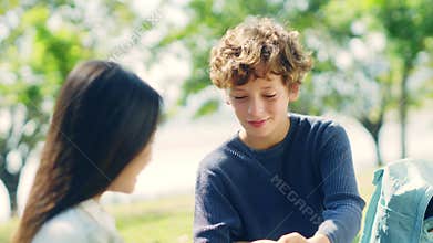 Caucasian boy giving present to asian girl