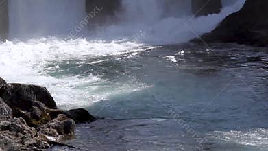 Hydroelectric power station, water flowing and falling, alternative ecologic energy, fast mountain river on a sunny