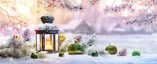 Christmas Lantern On Snow With Fir Branch in the Sunlight