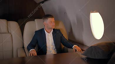 Portrait of businessman sitting in business jet armchair