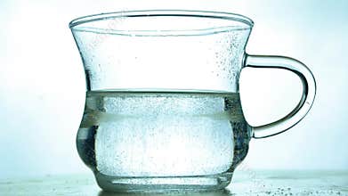 Mineral water, soda is fizzing on white background. Glass of healthy drink water and bubbles,