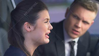 Young family arguing in car, wife crying helplessly, relationship breakup