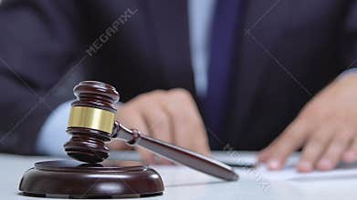 Police putting handcuffs on lawyer signing documents and hitting gavel, law