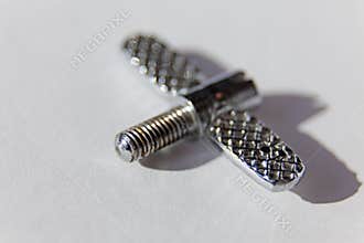 A screw similar to a butterfly that is part of a sewing machine