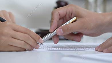 Female crime witness on lawyer appointment signing evidence document, court