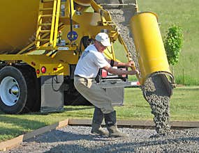 Worker directs the flow of concrete