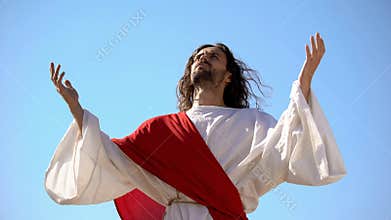 Jesus raising hands to sky and praying, resurrection and ascension of Christ