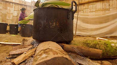 Indigenous Old Woman Cooking In A Primitive Kitchen In The Amazon Rainforest
