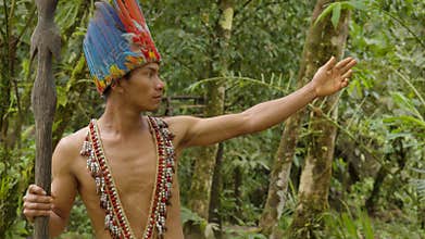 Indigenous Warrior Showing The Viewer The Amazon Rainforest
