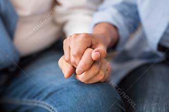 Love and support concept. Senior couple tenderly holding hands