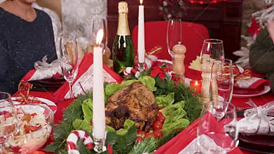 Adult woman putting down on the christmas table delicious turkey