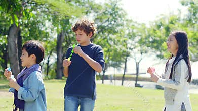 Asian and caucasian children playing in park