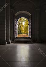 Beautiful old wooden door leading out to path in autumn trees
