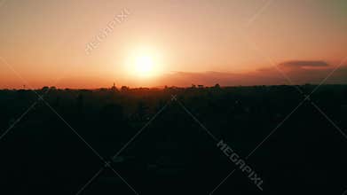 Aerial view of golden sunset above tropical island with resorts and hotels