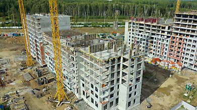 Busy construction site and construction equipment aerial. Real construction site industrial skyscraper building
