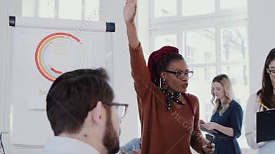 Multiethnic healthy workplace. Young black coach woman speaking at team meeting at modern office slow motion RED EPIC.