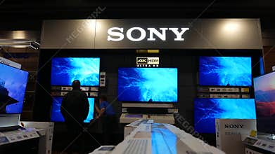 Motion of shopper looking new TV to buy inside store