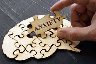 Anxiety. Hand holds on part of puzzles from brain