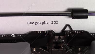 The words `Geography 101 ` being typed on a typewriter