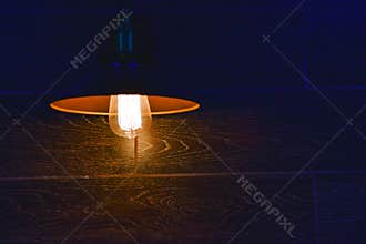 Red colored edison style lamp on a wall