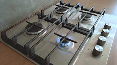 Kitchen one small burner turning on stove, cooking home flame, hand turns natural gas