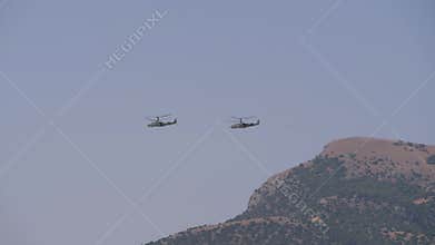 Flying a couple of helicopters over the mountains. Aerobatics.