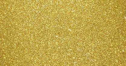 Gold glitter background, sparkling shimmer glow particles texture. Golden light sparks and glittering foil sequins background with