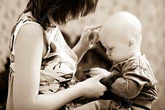 Black and white photo baby sitting on mom lap