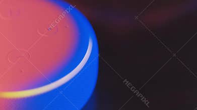 White Amazon Alexa Echo Dot 3rd Generation with different light colors effects..