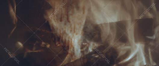 Fire behind a dirty glass in the fireplace