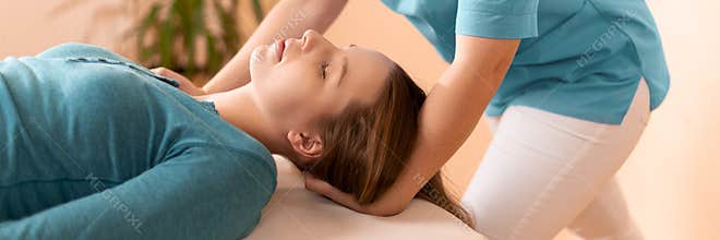 Female physiotherapist or a chiropractor adjusting patients neck. Physiotherapy, rehabilitation concept. Cropped shot banner.