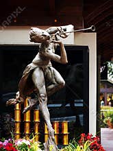 Bronze statue of woman playing the flute