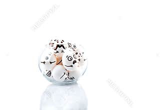 Eggs with drawn cartoon faces in a glass vase isolated on white background.