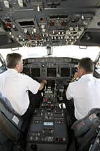 Airplane pilots in cockpit preparing to takeoff