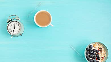 Stop motion animation with ringing alarm clock, coffe with milk, bowl of cereal and text Good morning. Healthy breakfast, beginnin