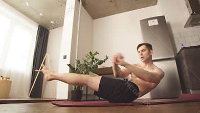 Sportsman doing crossfit at home during quarantine. Fitness exercises for weight loss.