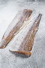 Raw fillet of hake fish. White background. Top view