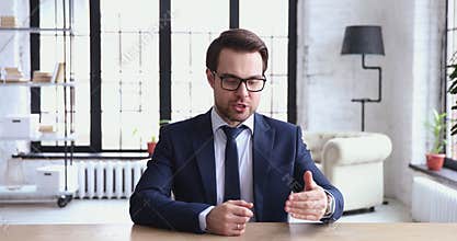 Young ceo speaking to camera recording business video presentation