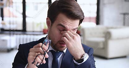 Tired businessman touching itchy dry eyes having conjunctivitis problem