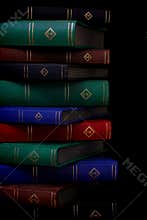 Hardback books against dark background