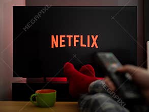 UK, March 2020: TV Television feet up watching Netflix