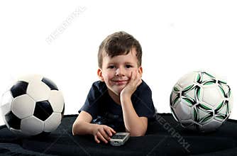 Small boy recreation on sofa with two balls