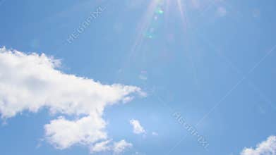 Passing white clouds in sunny blue sky
