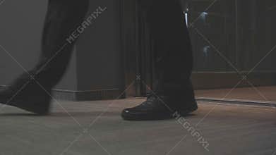 Man in black coming out of elevator. Stock. close-up of elevator doors opening and man in black clothes getting out