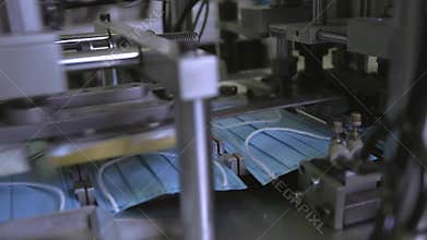 Medical mask on conveyor belt in the workshop