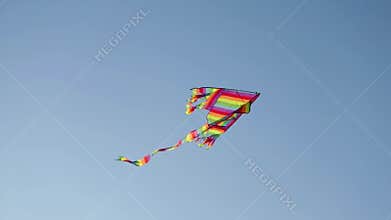 Slow motion footage of a kite flying over a blue sky