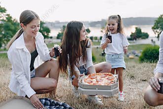 Picnic friends with pizza and drinks, sunny day, sunset, company, fun, couples and mom with baby