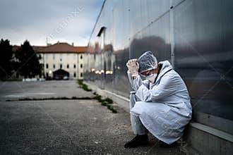 Frightened doctor for infectious diseases having mental nervous break down.Coronavirus COVID-19 exhausted physician in fear.