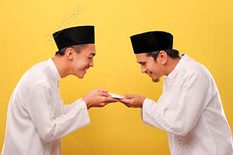 Young Asian Muslim man give alms to other muslim on Ramadan Kareem. It`s the best time to give alms to everyone need